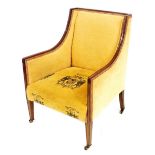 An Edwardian mahogany armchair, with channelled show frame, upholstered in gold fabric with stylised