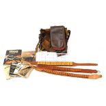 A group of shooting related items, to include a brown leather cartridge belt, canvas bag, various bo