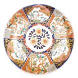 A 19thC Japanese Imari charger, decorated centrally with flowers surrounded by reserves of alternati