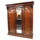 A Victorian mahogany compactum wardrobe, the outswept pediment over a central glazed door flanked by