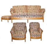 An Ercol light elm three piece lounge cottage style suite, comprising a three seater settee, and a p