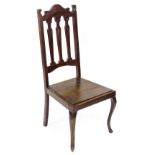 An Edwardian walnut side chair, with a pierced back, solid seat, on cabriole legs.