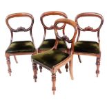 A set of four Victorian mahogany balloon back single dining chairs, with carved scroll and centre ra