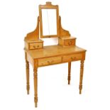 A pine dressing table, the raised back with a rectangular mirror plate, on shaped supports with two