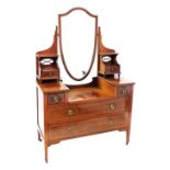 An Edwardian mahogany and chequer banded dressing table, the stepped top with a shield shaped mirror