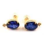 A pair of 18ct gold sapphire and diamond earrings, with an oval heat treated sapphire in full claw