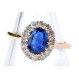 An 18ct rose gold Kyanite and diamond cluster ring, with an oval Kyanite approx 1.42ct, surrounded b