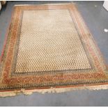 A Sarouk Mir cream ground rug, decorated with repeating botehs, within floral borders, 352cm x 149xm