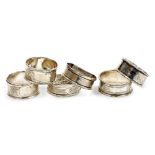 Six silver napkin rings, four bright cut decorated with flowers, scrolls, etc., Birmingham 1907 and