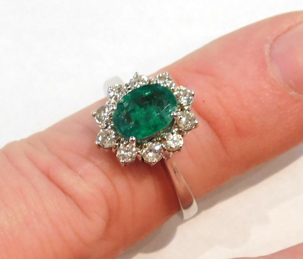 An 18ct white gold emerald and diamond ring, the oval cut emerald in a surround of brilliant cut dia - Image 4 of 4