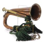 An early 20thC brass and copper military bugle, by G Potts and Company of Aldershot, 27cm wide.