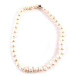A freshwater cultured pearl necklace, on a knotted white string strand, with a 9ct white gold ball c
