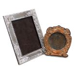 An early 20thC Art Nouveau copper mounted strut photograph frame, embossed with flowers and 'There's