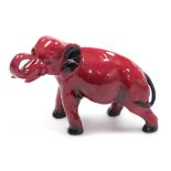 A Royal Doulton Flambe pottery model of an elephant, printed marks, 13.5cm high.