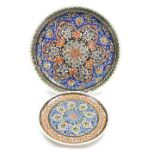 A Turkish pottery charger, decorated with Iznik floral and geometric motifs, 44cm wide, together wit