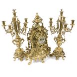 A 20thC German rococo style brass clock garniture, the clock with brass dial bearing enamel Roman nu