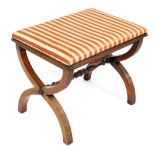 A Regency style mahogany stool, the padded top upholstered in striped fabric with X shaped reeded en