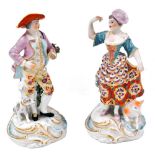 A pair of early 19thC porcelain figures, possibly Derby, modelled as a gallant with hound, and lady