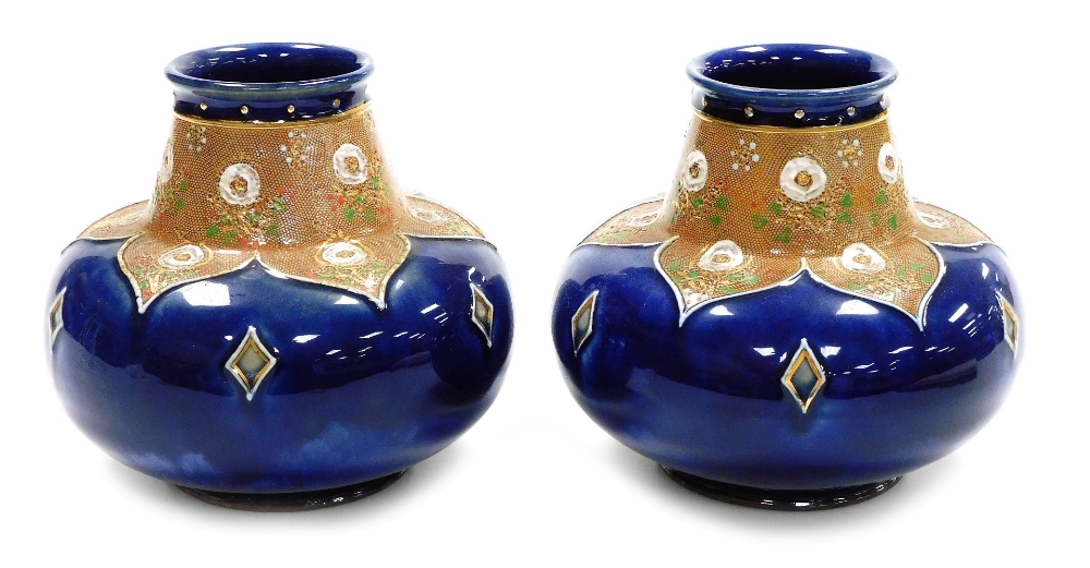 A pair of late 19thC Royal Doulton stoneware vases, each of cylindrical squat form, the raised neck
