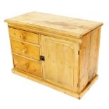 A Victorian pine dresser, with three graduated drawers having turned knop handles and a cupboard wit