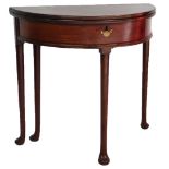 A George III mahogany demi lune fold over tea table, raised on turned legs over pad feet, 72cm high,