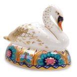 A Royal Crown Derby porcelain Swan paperweight, red printed marks and gold stopper, 11cm high.