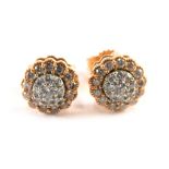 A pair of 9ct rose gold diamond scallop cluster earrings, each set with an arrangement of round bril