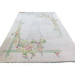 A European vintage beige ground rug, decorated with flowers within a bamboo frame, 398cm x 303cm.