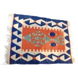 A Kilim blue ground rug, decorated with a geometric pattern, 115cm x 90cm.