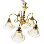 A brass five branch chandelier, with fluted moulded clear glass shades, 32cm high.