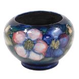 A Moorcroft Clematis pattern pottery vase, against a green to blue ground, signed W Moorcroft, impre