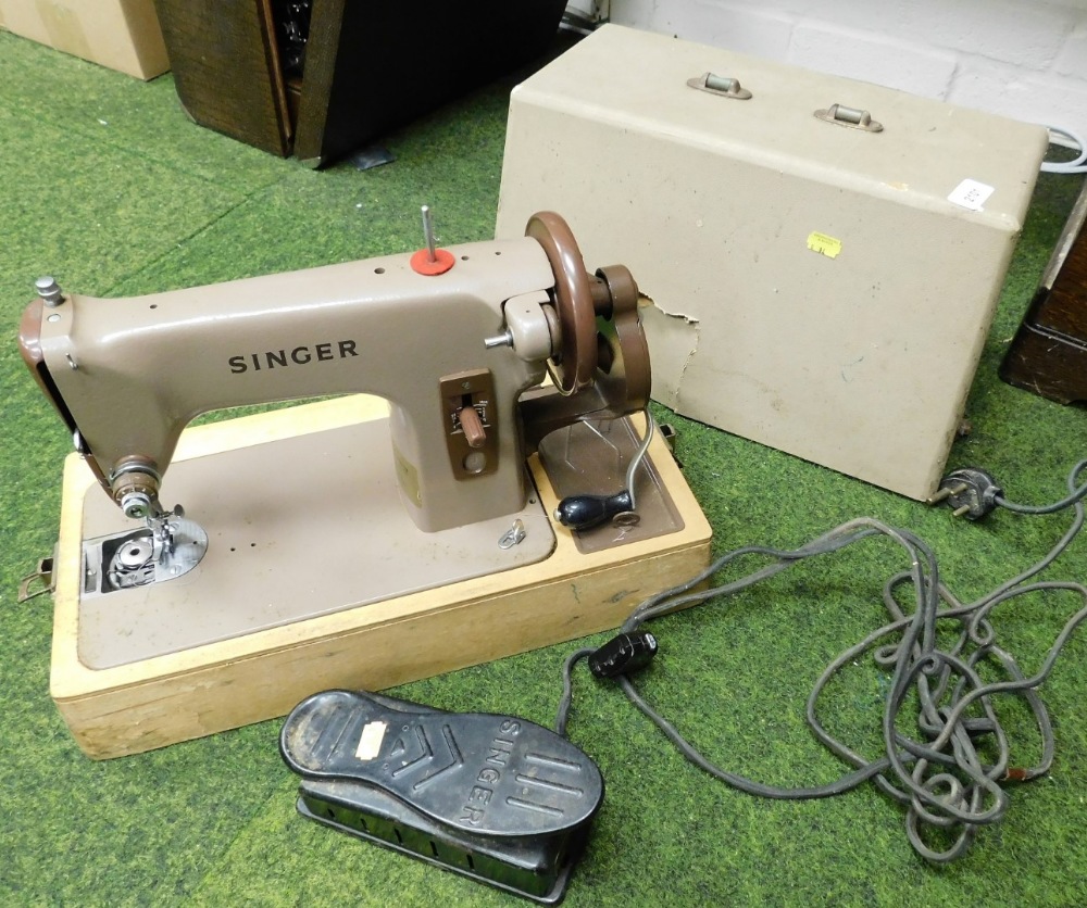 A cased Singer sewing machine.