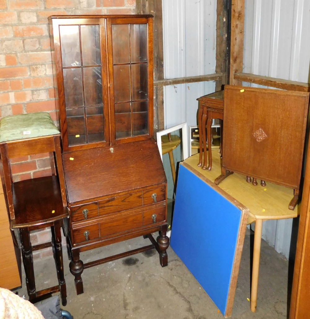 A group of furniture, to include an oak bureau bookcase, oak drop leaf table, nest of tables, oak fi