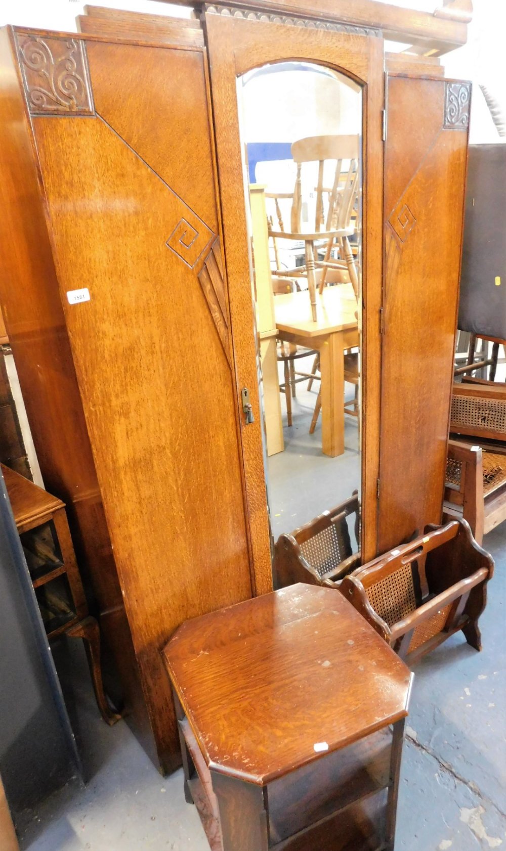 A mid century oak wardrobe, the central panel with a glazed door, on stand, approx 192cm high, 115cm