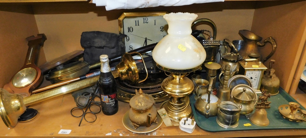 A group of brassware, to include chargers, cigarette stand, mantel clock, oil lamp converted to elec