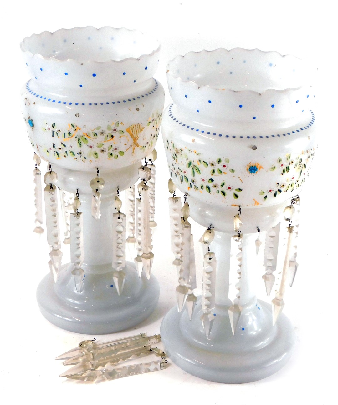 A pair of late 19thC milk glass lustres, decorated in enamel with a band of flowers, with clear pris