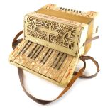 A 1930s Riosa piano accordion, twenty four button, with a faux mother of pearl case, 34cm wide.