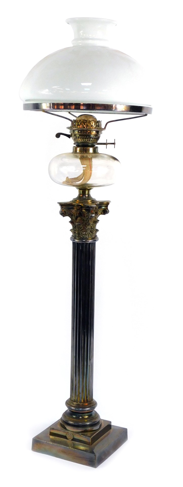 A Victorian silver plated Corinthian column oil lamp, with a clear glass reservoir and white glass s