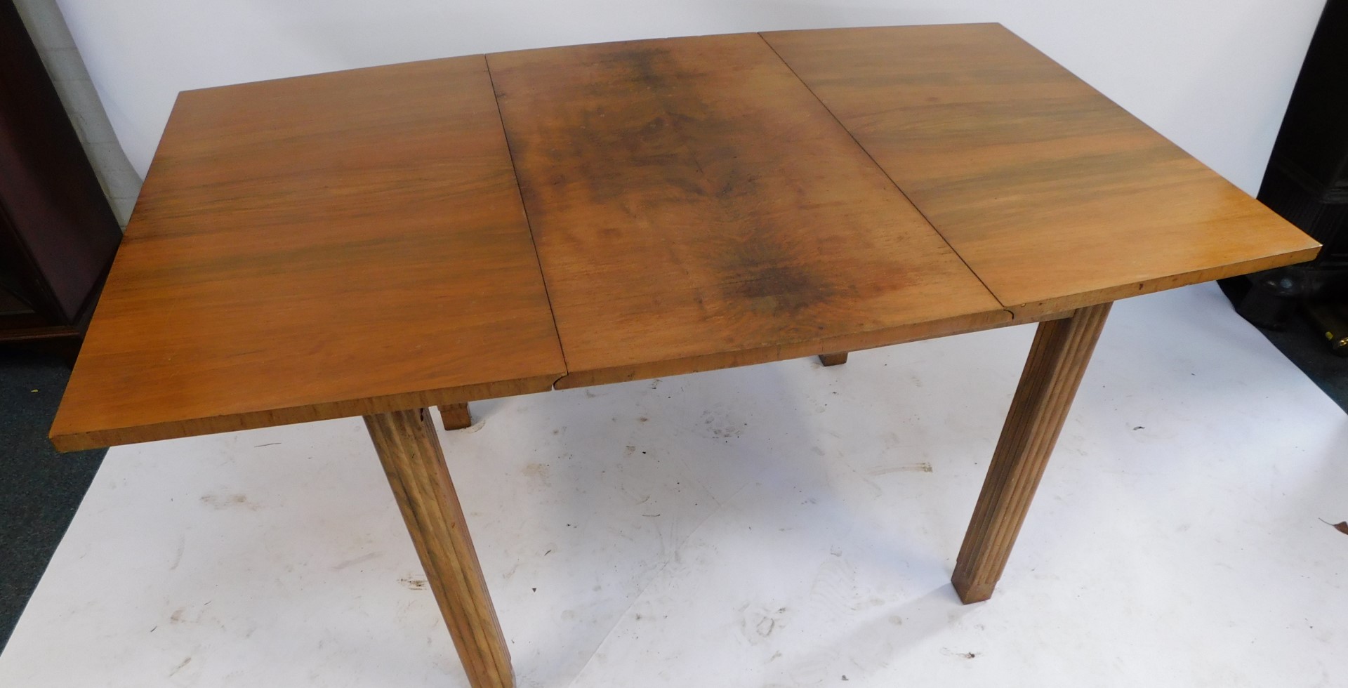 A mid century walnut drop leaf table, with quarter veneered top, on reeded column legs, 76cm high, 9 - Image 3 of 3