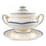 A Wedgwood early 19thC Cream Ware soup tureen cover and stand, painted in blue and white, with a flo