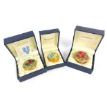 Three Moorcroft Pottery miniature enamel pill boxes, comprising one decorated in the