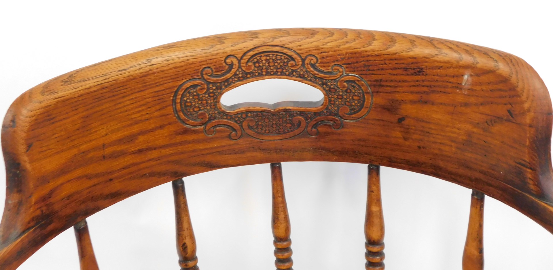 An early 20thC oak Captain's chair, with a carved floral back and shaped supports, on twin banded le - Image 2 of 3