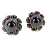 A pair of garnet cluster earrings, each formed as a floral cluster, with cabachon central stone, in