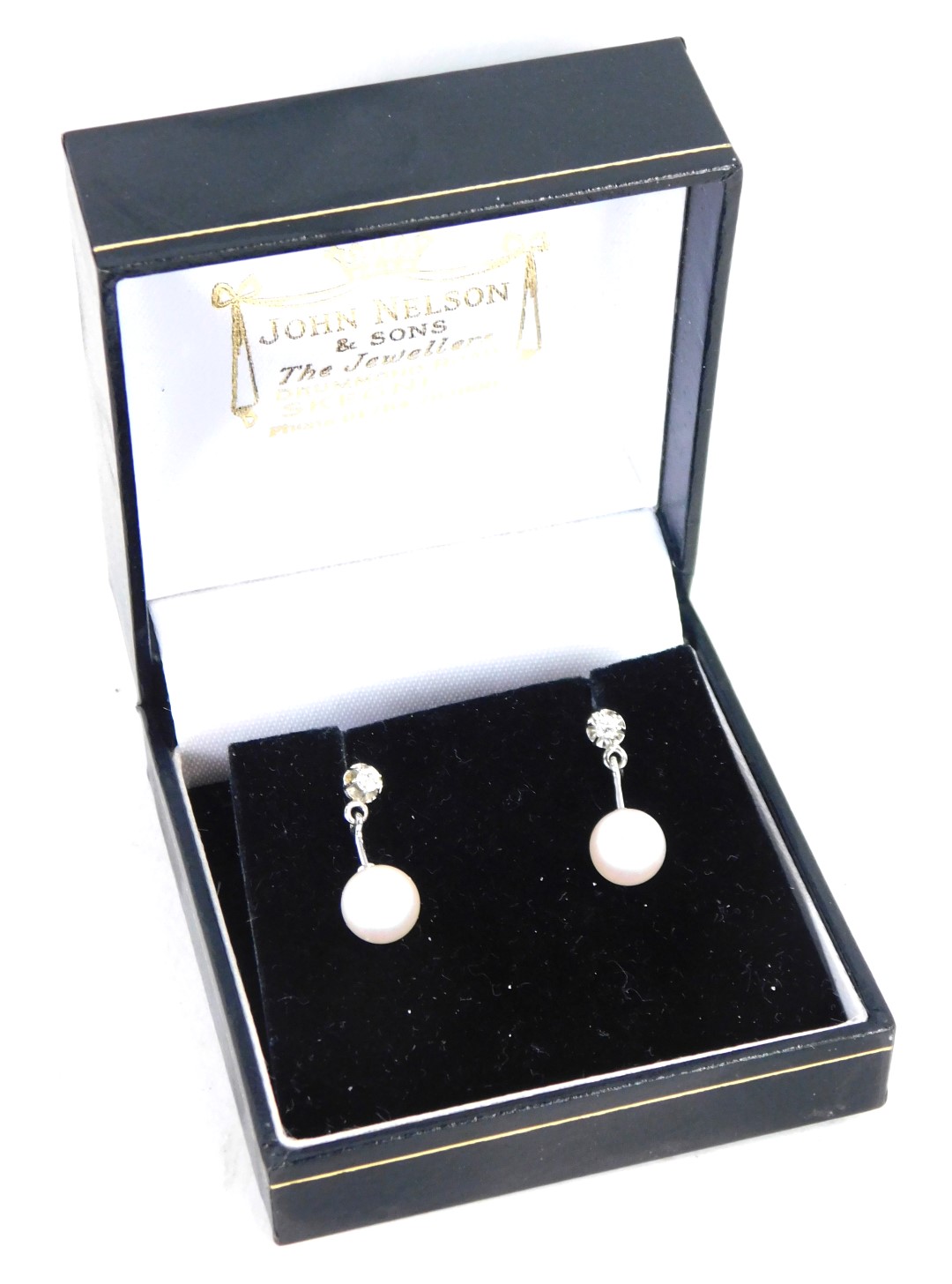 A pair of 18ct white gold cultured pearl and diamond drop earrings, each with a tiny diamond in four