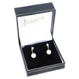 A pair of 18ct white gold cultured pearl and diamond drop earrings, each with a tiny diamond in four