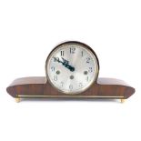 A 1950's German walnut cased mantel clock, circular silvered dial bearing Arabic numerals, eight day