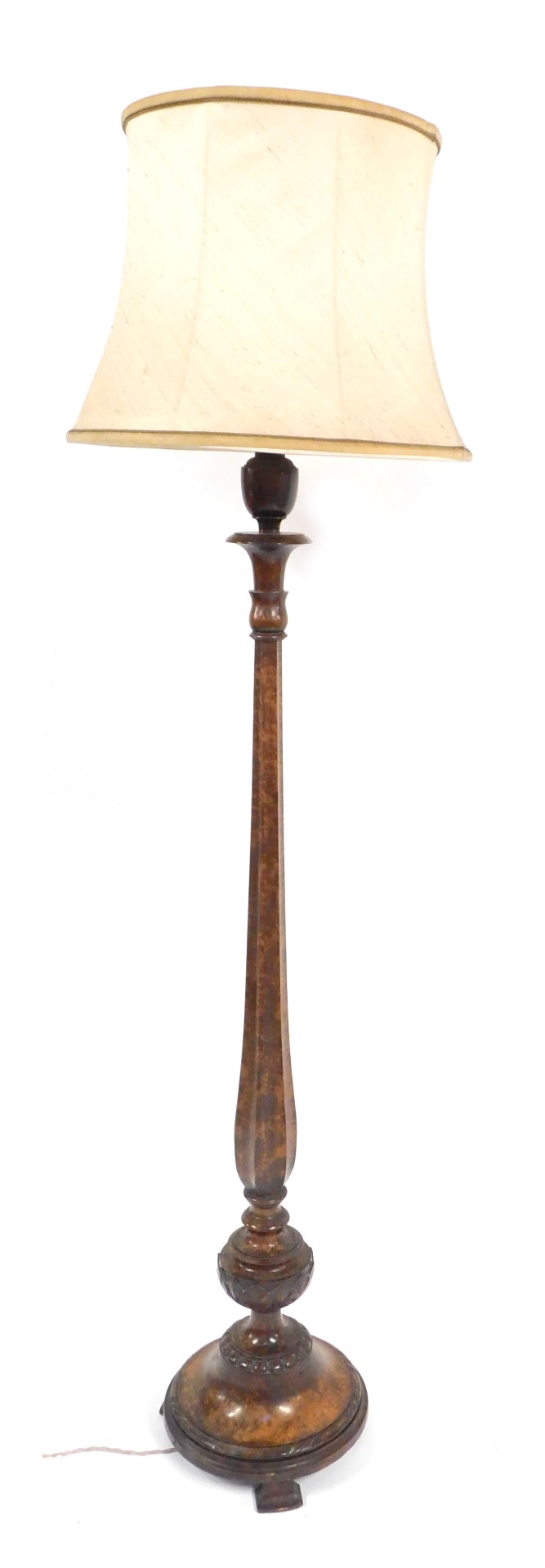 A early 20thC walnut standard lamp, on a hexagonal reeded column, on circular foot with dark mouldin