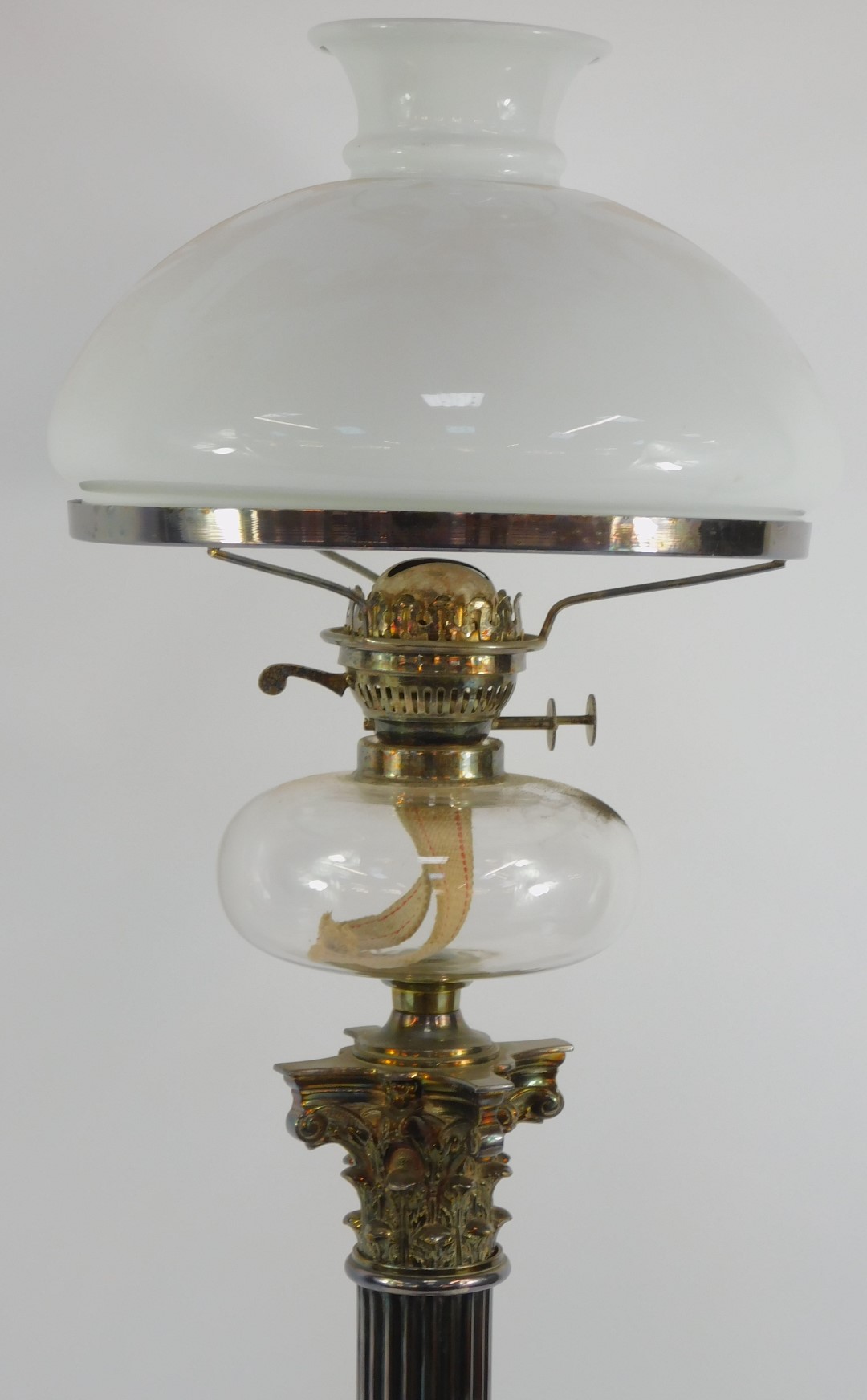 A Victorian silver plated Corinthian column oil lamp, with a clear glass reservoir and white glass s - Image 2 of 4