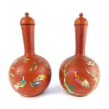 A pair of late 19thC terracotta bottles and lids, enamel decorated with exotic birds, number 9987, 3