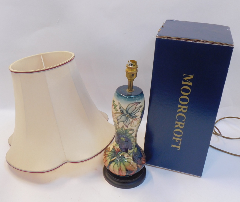 A Moorcroft Pottery table lamp decorated in the Karli pattern, with shade, painted and impr